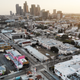 An aerial view of mostly empty streets and parking lots with the downtown skyline in the background amid the coronavirus pandemic on April 4, 2020 in Los Angeles, California.